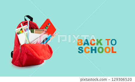 The backpack opens with the arrangement of school supplies and a message of Back to School on a colored background. Concept of Back to School 129306520