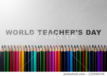 Row of colored pencils with the message of World Teacher Day on a grey background. Concept of World Teacher Day 129306544