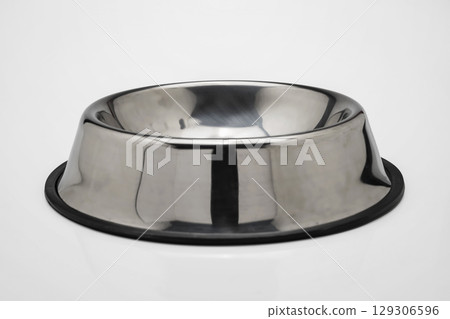 Empty stainless steel bowl tray for pet food isolated over a white background Empty stainless steel bowl tray for pet food isolated over a white background 129306596