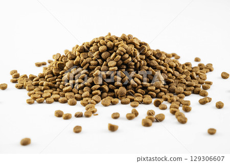 Dog and cat dry food splattered isolated over a white background Dog and cat dry food splattered isolated over a white background 129306607