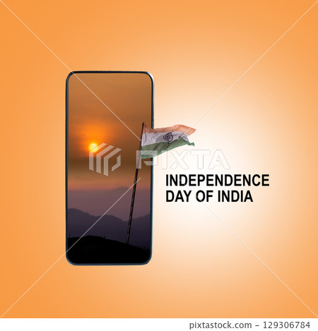 Indian flag waving in the sky with a sunrise scene background on the cellphone screen. India Independence Day. Collage art Indian flag waving in the sky with a sunrise scene background on the cellphone screen. India Independence Day. Collage art 129306784
