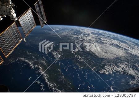 View of Earth from space captured during low-light conditions showcasing urban lights and natural atmosphere 129306787