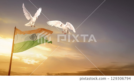 Indian flag waving in the sky with a flying pigeon bird and a sunrise scene background. India Independence Day Indian flag waving in the sky with a flying pigeon bird and a sunrise scene background. India Independence Day 129306794