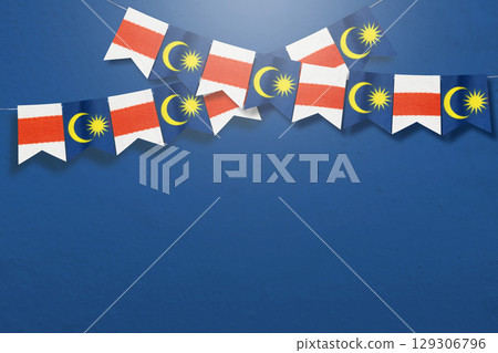 Malaysian flag hangs to celebrate Malaysia Independence Day with a blue background Malaysian flag hangs to celebrate Malaysia Independence Day with a blue background 129306796