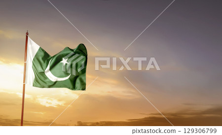 Pakistan national flag waving in the sky with a sunrise scene background. Concept of Pakistan Independence Day 129306799