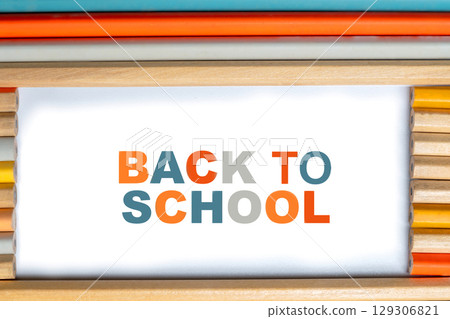 Row of wooden pencils with a message of Back to School isolated over a white background. Concept of Back to School 129306821