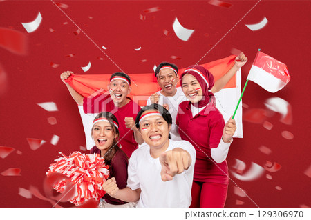 Indonesian southeast asian people celebrate Indonesia Independence Day on the 17th of August by holding the Indonesian national flag. Concept of Kemerdekaan Indonesia Indonesian southeast asian people celebrate Indonesia Independence Day on the 17th of August by holding the Indonesian national flag. Concept of Kemerdekaan Indonesia 129306970