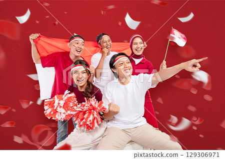 Indonesian southeast asian people celebrate Indonesia Independence Day on the 17th of August by holding the Indonesian national flag. Concept of Kemerdekaan Indonesia 129306971