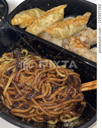 A classic Korean-Chinese combo of jajangmyeon with thick, chewy noodles coated in rich black bean sauce, served alongside crispy tangsuyuk, deep-fried pork with sweet and sour sauce. 129307268