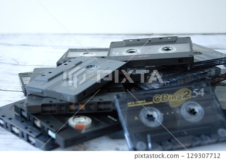 Piles of cassette tapes 129307712