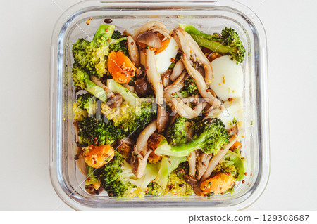 Warm salad of broccoli, shimeji mushrooms and boiled eggs with mustard 129308687
