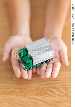 Elementary school boy holding a model truck Elementary school boy holding a model truck 129308874