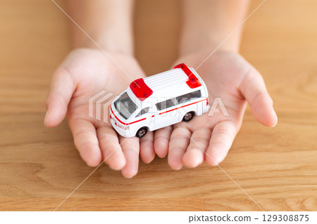 Elementary school boy holding a model ambulance 129308875