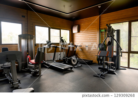Small Modern gym with a variety of equipment Small Modern gym with a variety of equipment 129309268