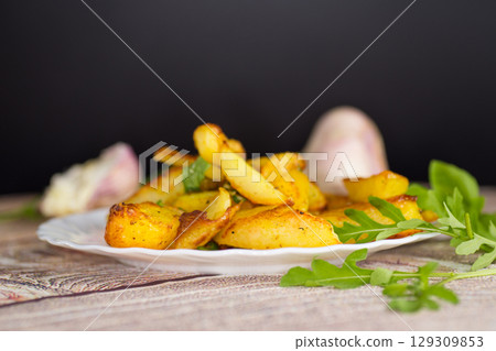 A hearty dish - potatoes with seasonings and garlic 129309853