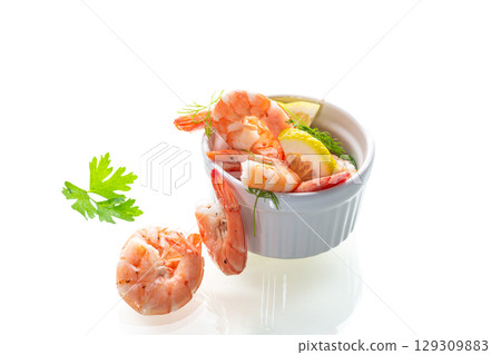 Close-up of boiled shrimps with lemon slices Close-up of boiled shrimps with lemon slices 129309883