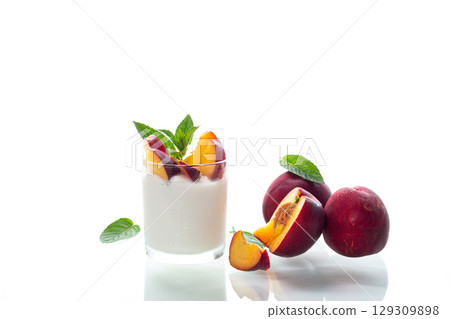 Whole and cut nectarines with yogurt on clean background 129309898
