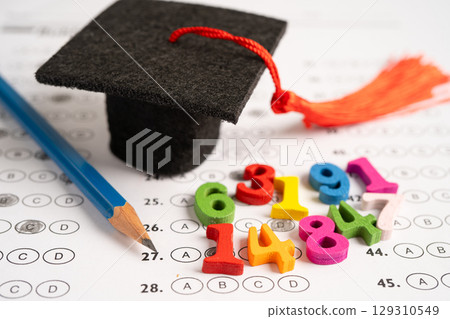 Math Number colorful with graduation hat and pencil on answer sheet paper. Math Number colorful with graduation hat and pencil on answer sheet paper. 129310549
