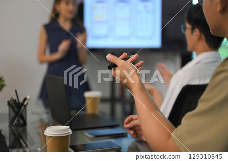 Group of colleagues collaborating during a creative strategy session with digital visuals 129310845