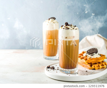 coffee moment, two iced lattes in tall ribbed glass coffee moment, two iced lattes in tall ribbed glass 129311976