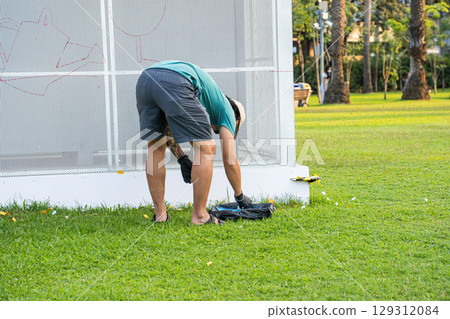 Artist Prepares Tools for Wall Art 129312084