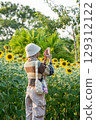 Girl Taking Sunflower Photo 129312122