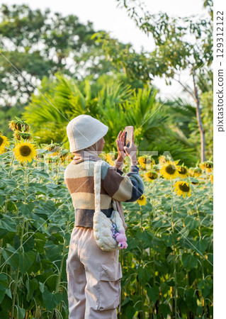 Girl Taking Sunflower Photo Girl Taking Sunflower Photo 129312122