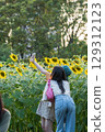 Girls Taking Selfie with Sunflowers 129312123