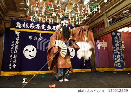 Iwami Kagura (Night Kagura) Performers dancing on the shrine's worship hall stage Iwami Kagura (Night Kagura) Performers dancing on the shrine's worship hall stage 129312269
