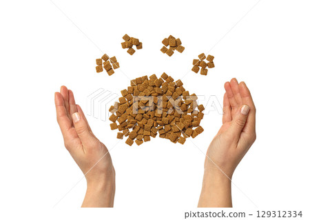 Hands holding pet food shaped like a paw, isolated on white, PNG 129312334