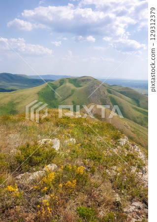 vertical view of a mountainside with rocky terrain vertical view of a mountainside with rocky terrain 129312379
