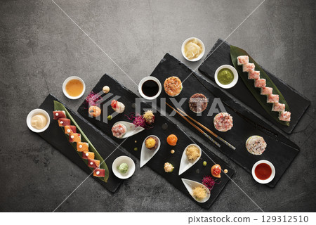 Mix of japanese sushi rolls and sauces Mix of japanese sushi rolls and sauces 129312510