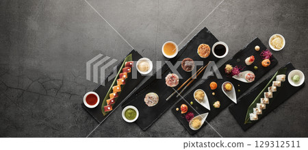 Mix of japanese sushi rolls and sauces Mix of japanese sushi rolls and sauces 129312511