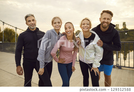 Group portrait of happy diverse friends on city bridge after active outdoor workout Group portrait of happy diverse friends on city bridge after active outdoor workout 129312588