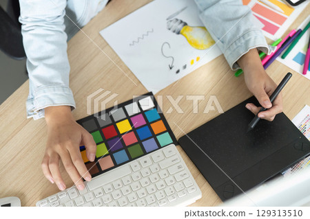 Top View of Designer Working with Color Swatches and Digital Tools Top View of Designer Working with Color Swatches and Digital Tools 129313510