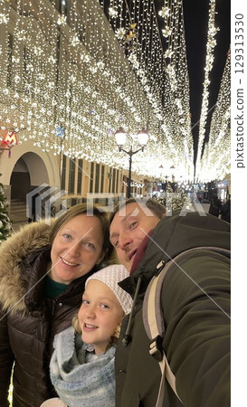 Family Enjoying Christmas Street Illuminations 129313530