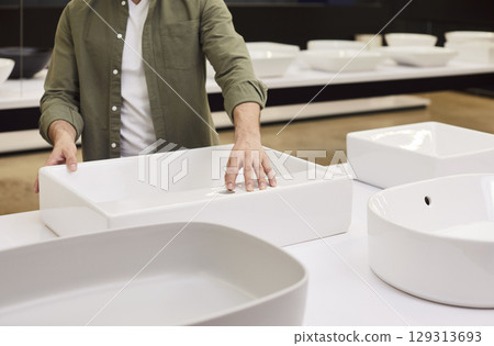 Consumer close up choosing, buying workstation sink essential home plumbing supplies among selection Consumer close up choosing, buying workstation sink essential home plumbing supplies among selection 129313693