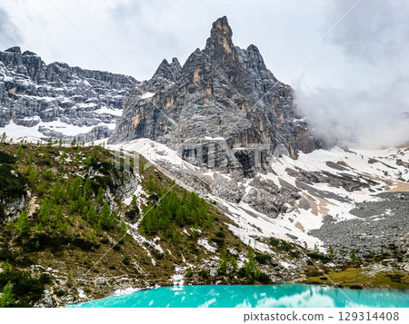 Aerial drone view of beautiful Lake Sorapis, Lago di Sorapis, in Dolomites, popular travel destination in Italy. Blue green lake in Italian Dolomites 129314408