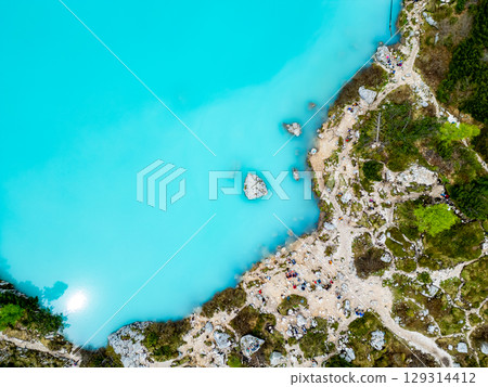 Aerial drone view of beautiful Lake Sorapis, Lago di Sorapis, in Dolomites, popular travel destination in Italy. Blue green lake in Italian Dolomites Aerial drone view of beautiful Lake Sorapis, Lago di Sorapis, in Dolomites, popular travel destination in Italy. Blue green lake in Italian Dolomites 129314412