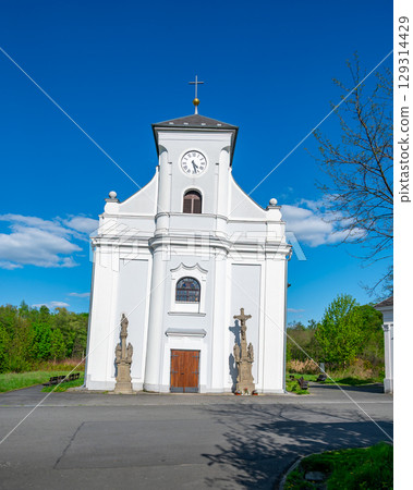 Frontal view of the leaning Church of St. Peter of Alcantara in Karvina, Czech Republic. The iconic tilted structure stands as a unique reminder of the area's mining history. Frontal view of the leaning Church of St. Peter of Alcantara in Karvina, Czech Republic. The iconic tilted structure stands as a unique reminder of the area's mining history. 129314429