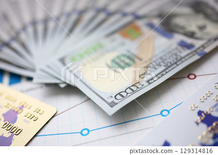 Stacks of currency and credit cards arranged artistically, symbolizing financial growth and investment opportunities 129314816