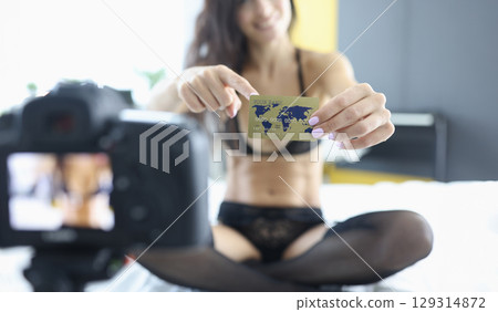 Capturing confidence and allure in a creative photoshoot with a world map card highlighting connection and adventure 129314872