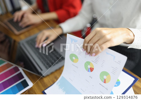 Collaboration in a modern office during a business meeting focused on data analysis and presentation of results Collaboration in a modern office during a business meeting focused on data analysis and presentation of results 129314876