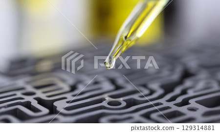 Close-up of a droplet of oil being prepared in a laboratory setting for scientific experimentation and exploration of new formulations Close-up of a droplet of oil being prepared in a laboratory setting for scientific experimentation and exploration of new formulations 129314881