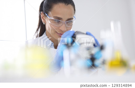Innovative scientist engaged in groundbreaking research in bright laboratory during afternoon hours 129314894