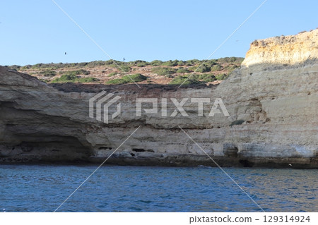 Sunlit Coastal Cliff in Algarve, Portugal Sunlit Coastal Cliff in Algarve, Portugal 129314924