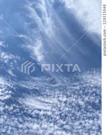 A blue sky with interesting cloud movements A blue sky with interesting cloud movements 129315048