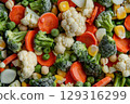 Close-up of assorted frozen vegetables including broccoli, carrots, corn, and cauliflower 129316299