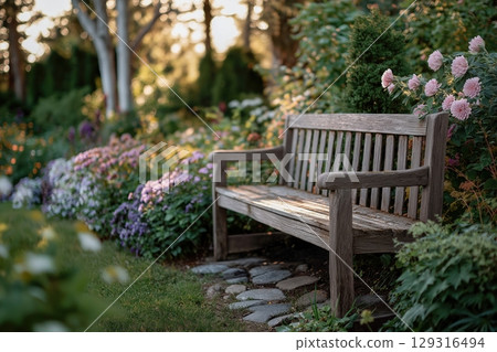 Wooden Bench Surrounded by Vibrant Flowers in a Tranquil Garden 129316494