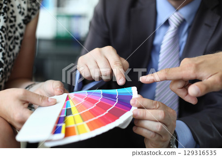 Exploring vibrant color palettes during a collaborative design meeting in a contemporary office setting 129316535